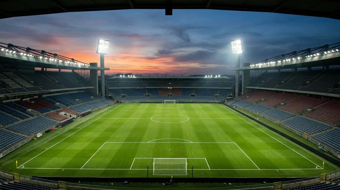 Floodlit football pitch at dusk before a major international knockout fixture